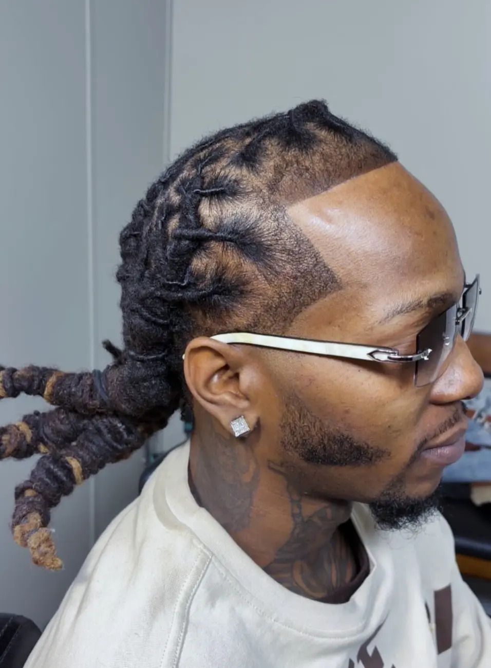 Braided style with a precise temple edge and beard