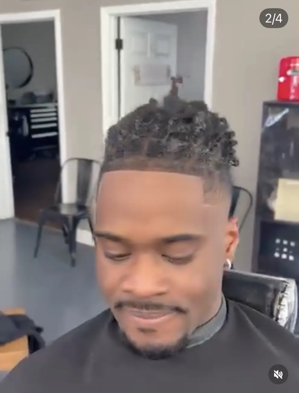Smiling client showing a finished twist style and line-up