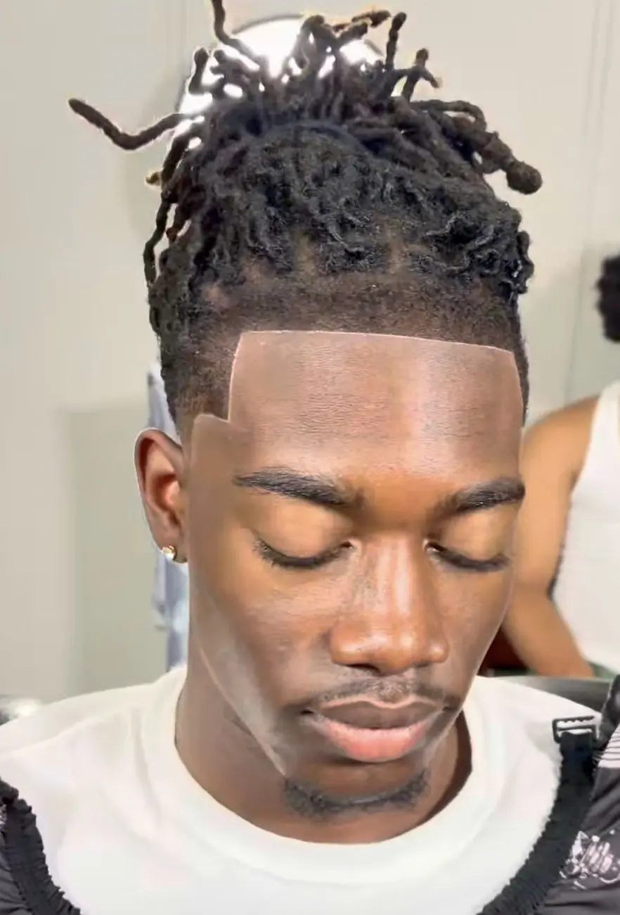 High skin fade beneath styled locs