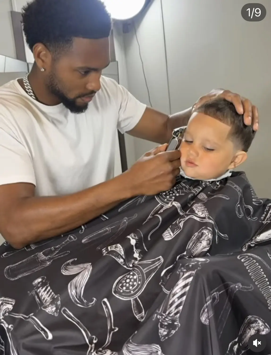Damon carefully lining up a young child in the barber chair